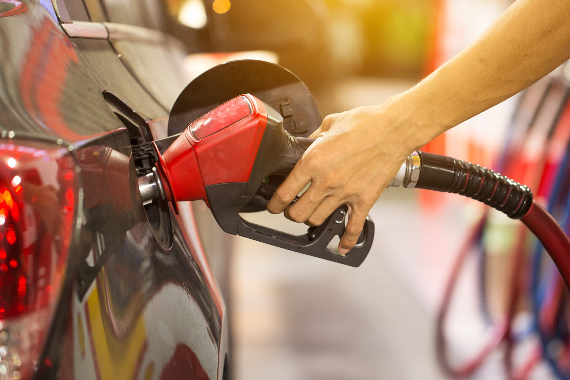 Pumping gas at gas pump. Closeup of man pumping gasoline fuel in car at gas station. Pumping gas at gas pump. Closeup of man pumping gasoline fuel in car at gas station.